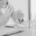 A person holding a pipette and test tube
